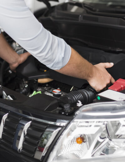 male-hands-taking-out-car-engine